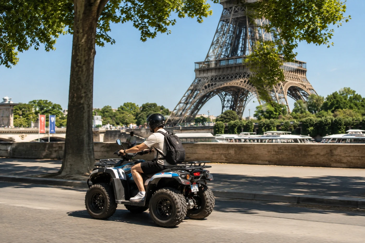 Quad rider along the Seine below the Eiffel Tower