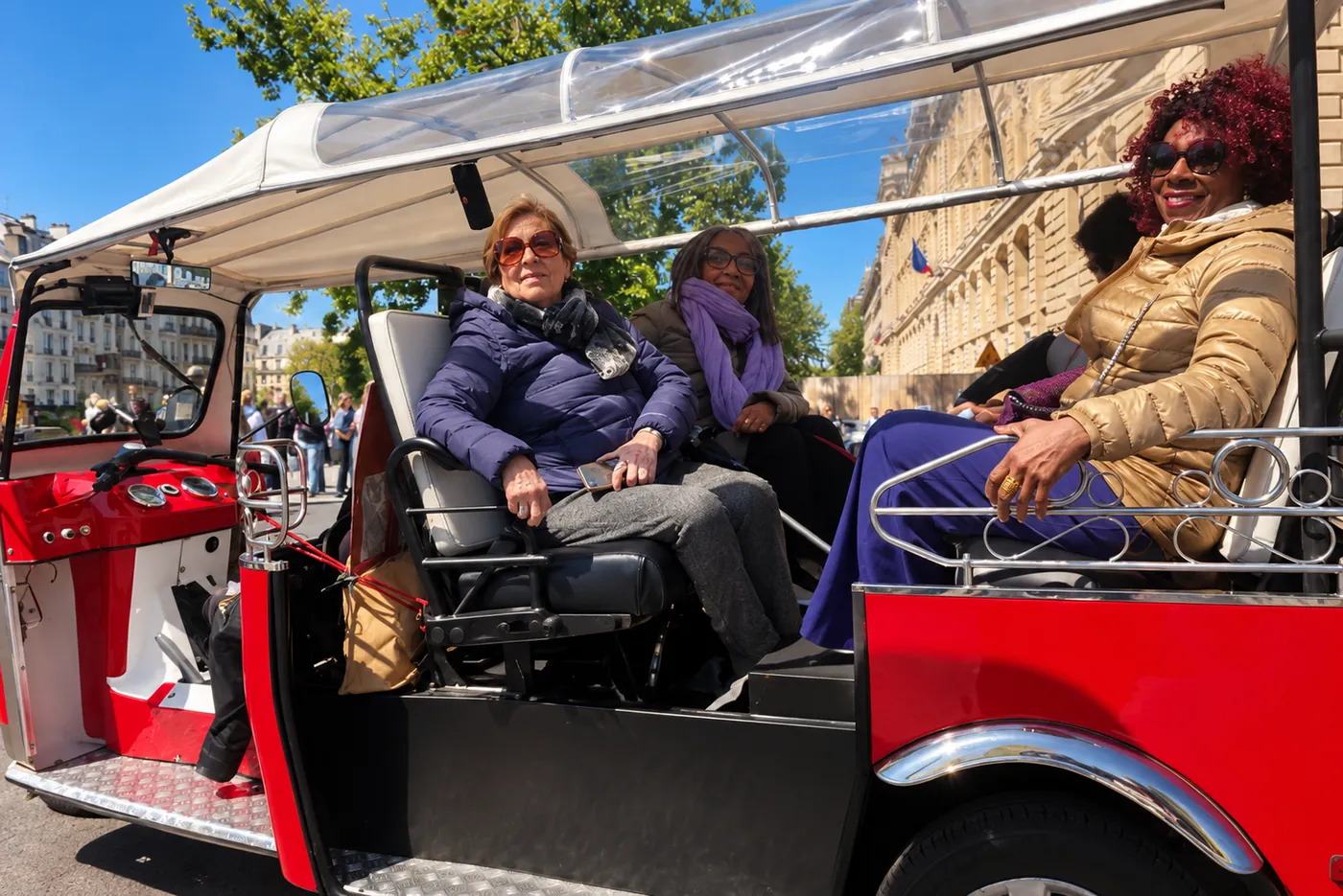 Guests enjoying a private tuk-tuk tour in Paris
